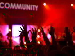 Arms reaching toward Community sign